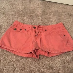 Light wash red/ pink shorts.